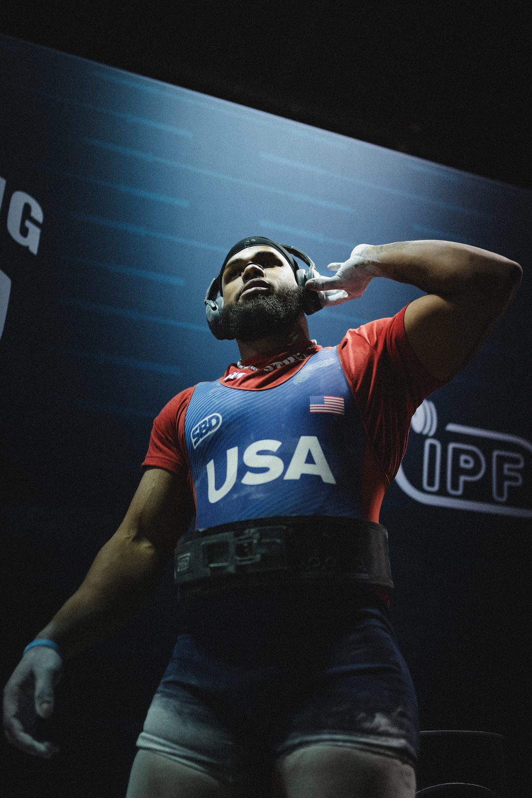Lifter in a USA singlet firing up before an attempt